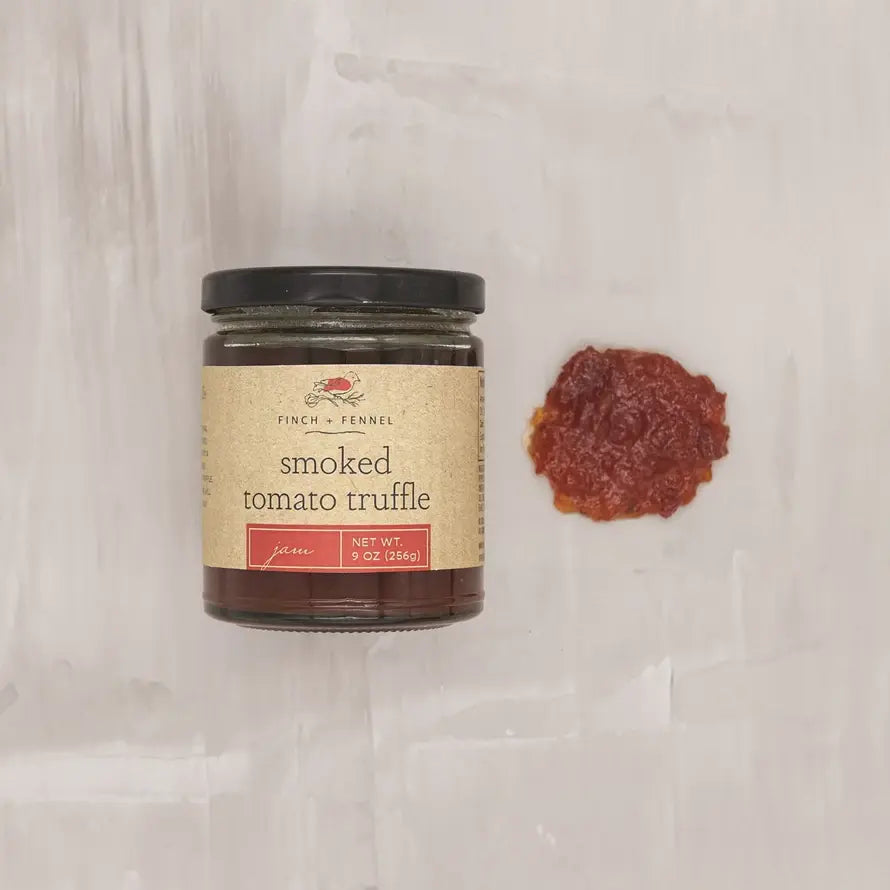 Jar of Smoked Tomato Truffle Jam with a red label on a white background.