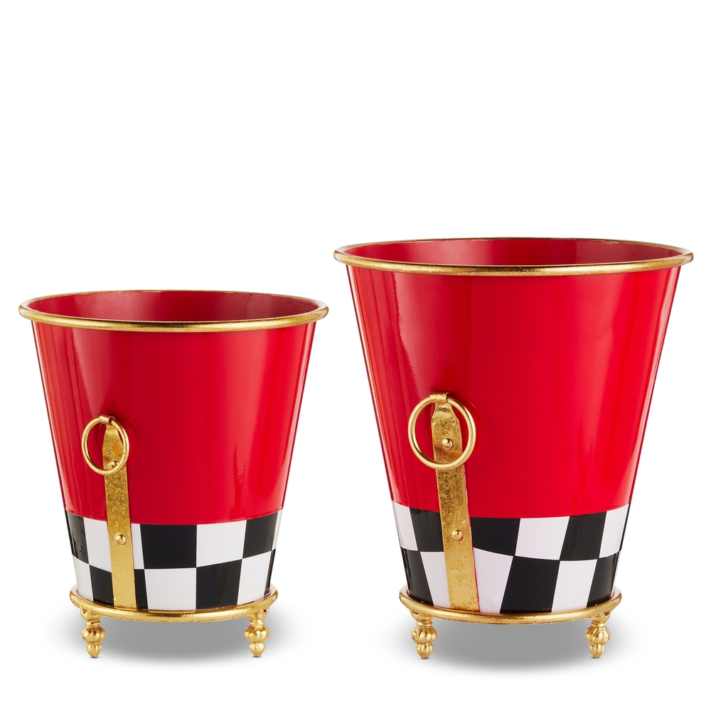 Two red metal footed planters with a black and white checkered base and gold ring handles.