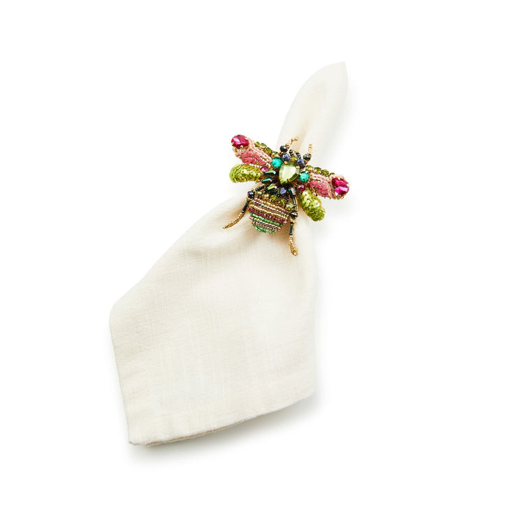 Beetle Napkin Ring featuring a colorful beaded insect design on a white linen napkin.