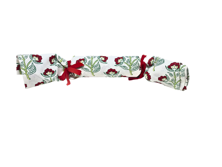 Rolled Christmas block print cotton towel with red floral design and red ribbon tie.