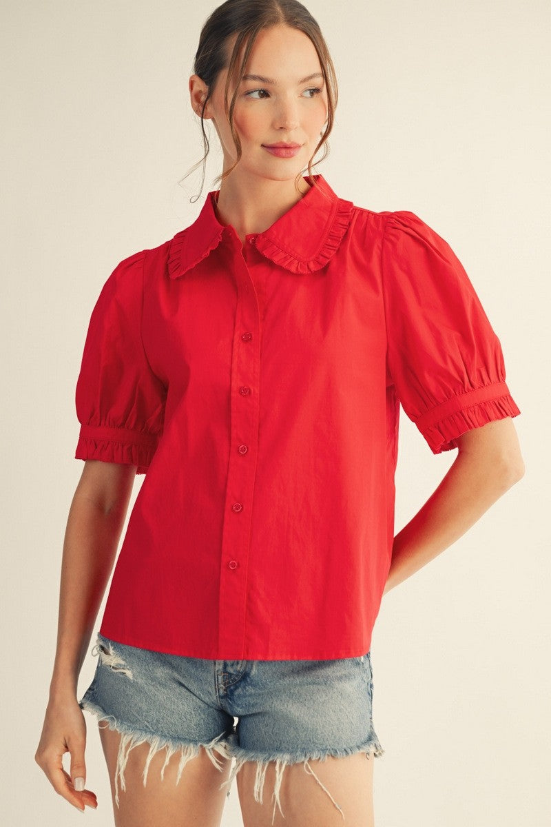 Solid white Zoe button-down top with Peter Pan collar, short puff sleeves, ruffled edges, and a relaxed silhouette made of cotton.