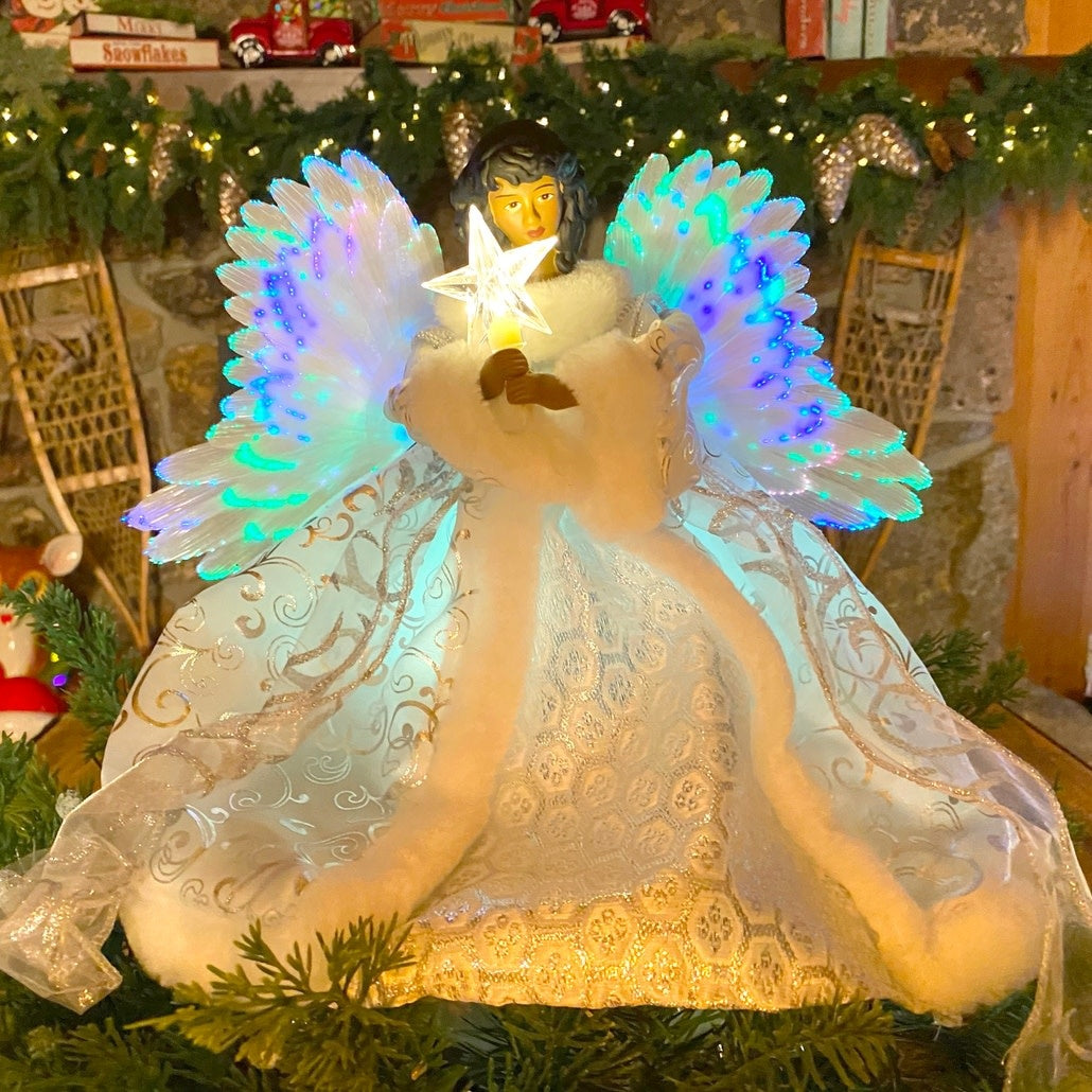 Black ceramic angel tree topper with animated wings illuminated by color-changing fiber optic lights and fabric outfit.