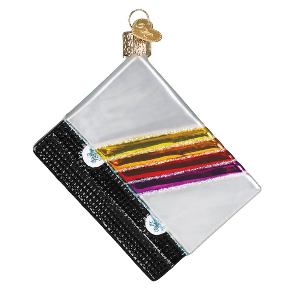 Glass VHS tape Christmas ornament with a black base, white label, and colorful rainbow stripes.