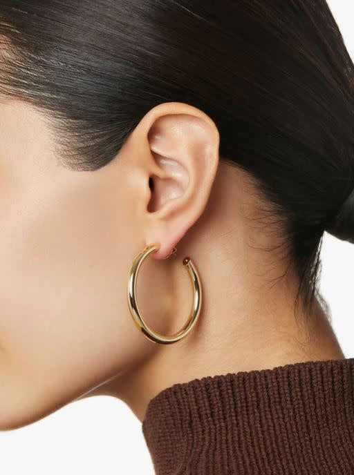 Medium gold hoop earrings with high-polish finish on hypoallergenic titanium posts