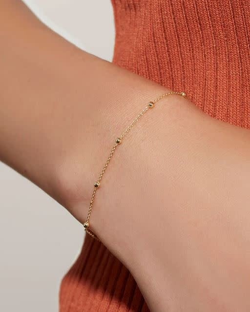 Delicate gold chain bracelet on recycled sterling silver with tiny bauble detailing