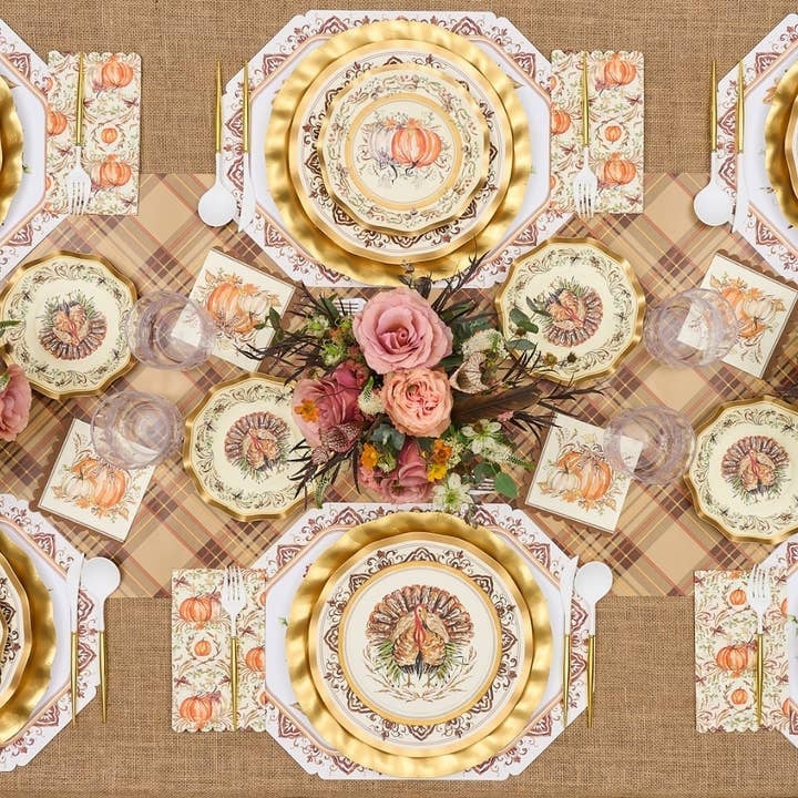Wavy-edge disposable dinner plate with gold foil rim and central turkey illustration on paper.