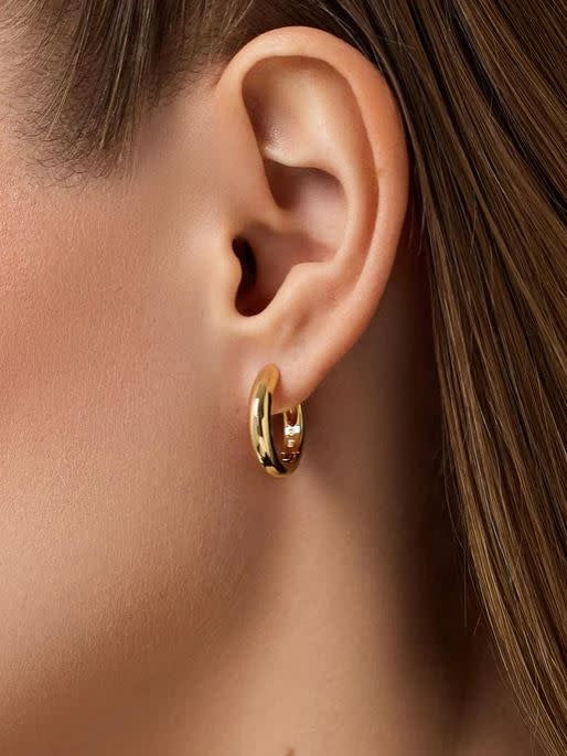 Chunky gold-plated brass hoop earrings with a stainless steel post hinge clasp.