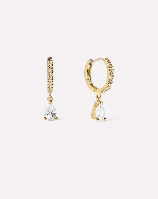 Gold-dipped huggie hoop earrings with cubic zirconia gems on a surgical steel post.