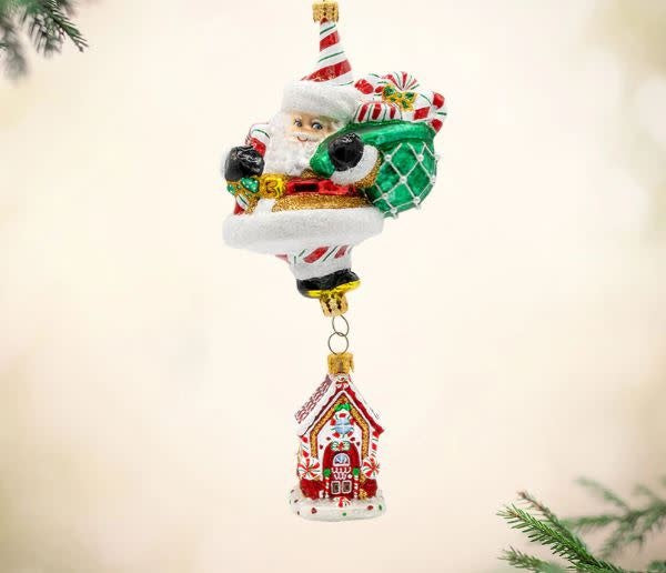 Gingerbread house ornament with Santa's treat-filled bag