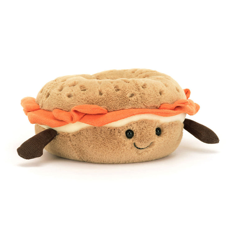 Jellycat Amuseables Bagel plush toy in golden polyester with sesame freckles and cream cheese details.