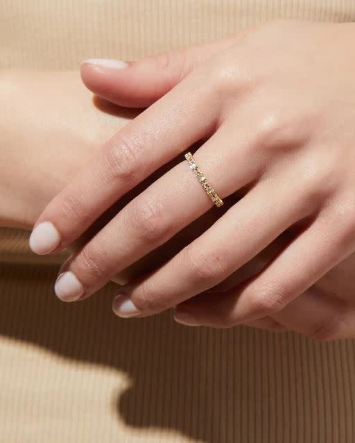 Darcy stackable ring in gold with baguette-cut and round cubic zirconia stones.