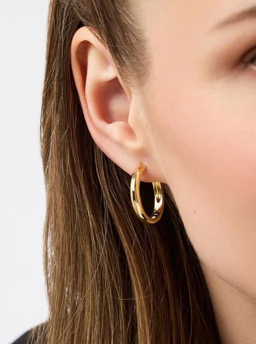 Large chunky gold hoop earrings with a hinge clasp on stainless steel post.