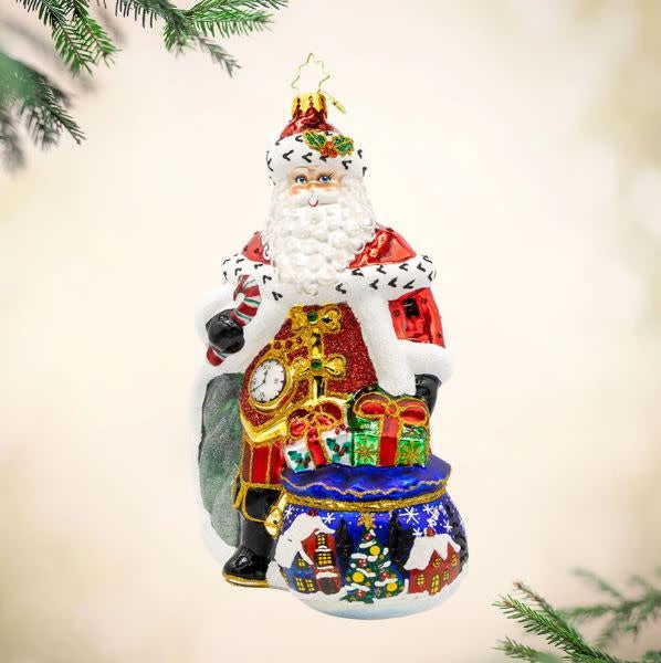 Majestic Santa figurine in royal red robe with sparkling crown holding a shiny staff.
