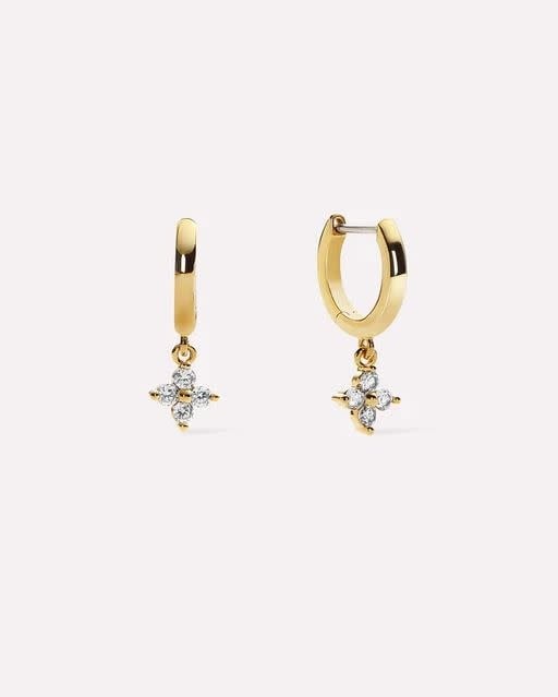 Gold huggie hoop earrings with cubic zirconia stars on a stainless steel post.