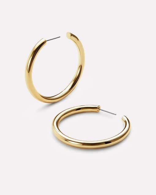Medium gold hoop earrings with high-polish finish on hypoallergenic titanium posts.