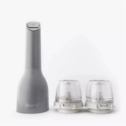 FinaMill electric spice grinder with two swappable ceramic grinding pods in sleek minimalist black and white design.