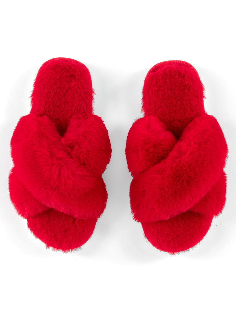 A pair of red Christina slippers featuring a plush faux fur finish and a crisscross strap design.