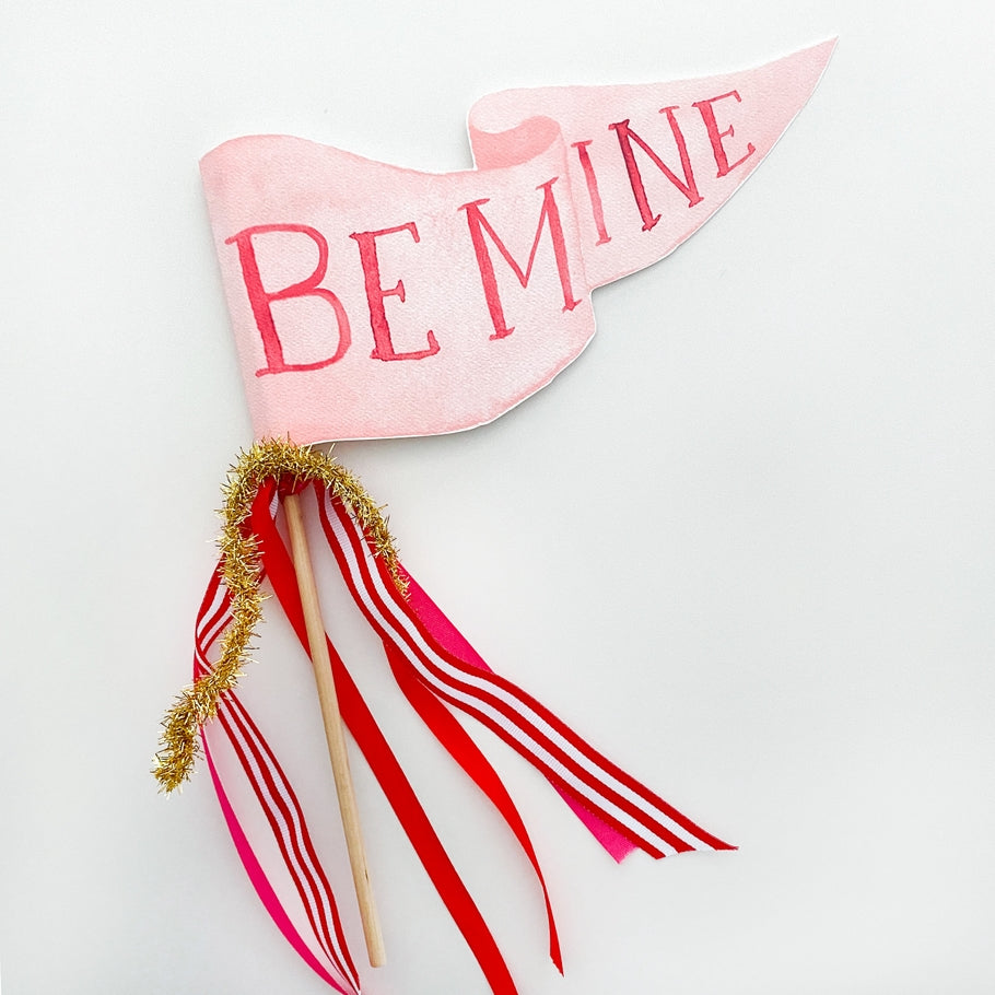Assembled wooden dowel party pennant featuring whimsical watercolor illustrations on textured paper.