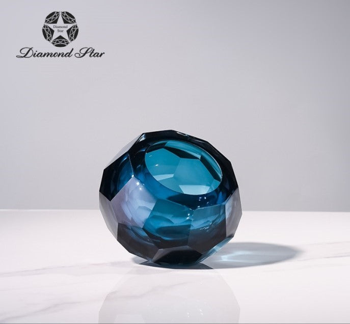 4.1 inch faceted blue glass vase with a geometric, diamond-cut design on a white surface.
