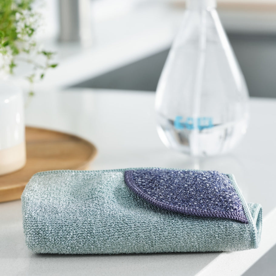 Square kitchen cleaning cloth with sewn-in scrubbing pocket on one side.