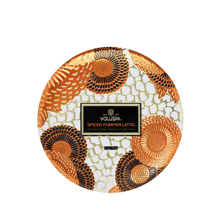 Top view of a Voluspa Spiced Pumpkin Latte 3-wick candle tin with an orange floral pattern.