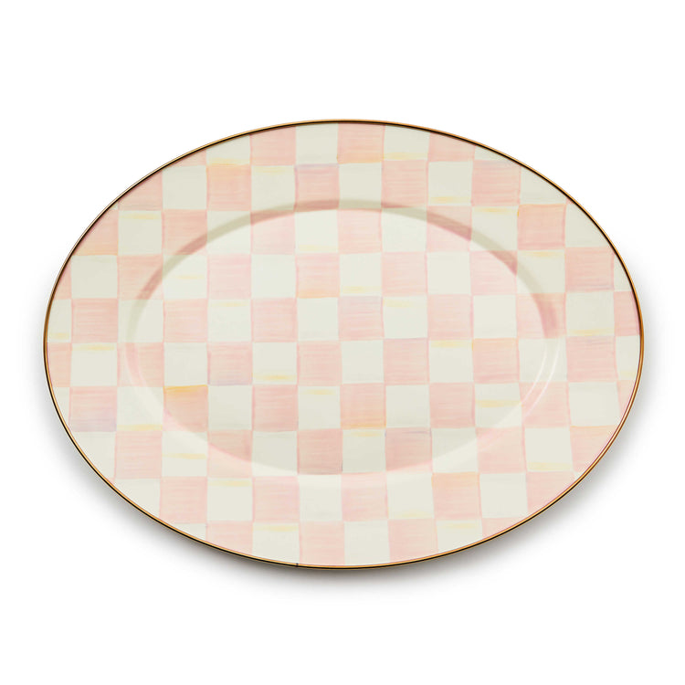 Oval platter with a hand-painted pink and white checkered pattern and a bronzed stainless steel rim.