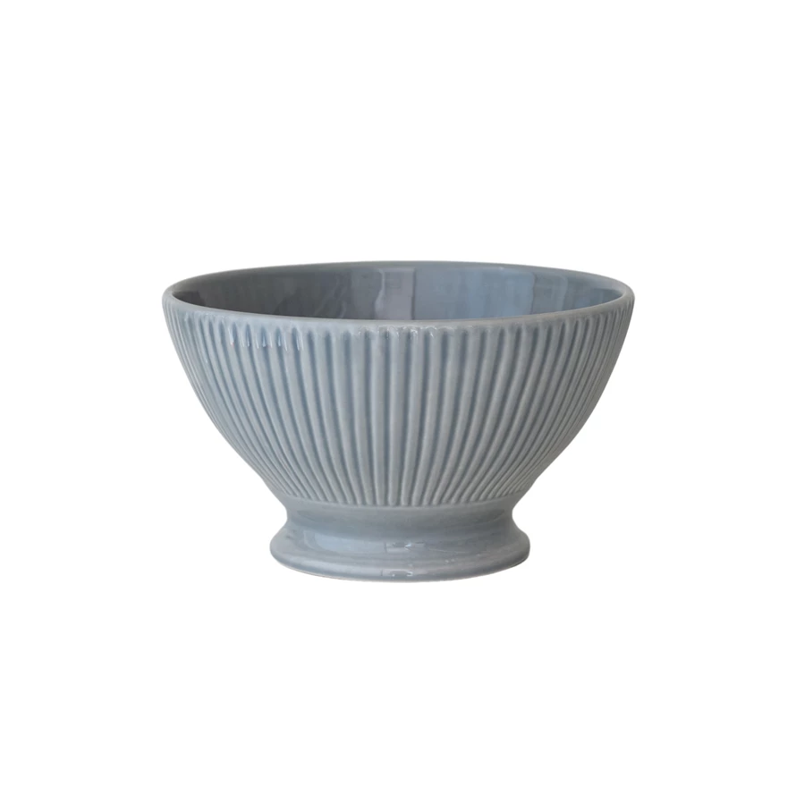 Reactive glaze stoneware fluted serving bowl with a round silhouette.