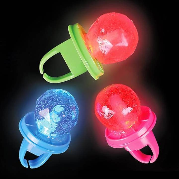 A child holding a flashing pop ring toy that lights up in multiple colors.