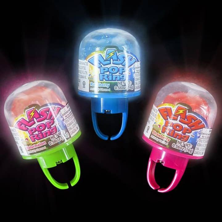A child holds a flashing pop ring toy that lights up in multiple colors with an interactive glowing design.