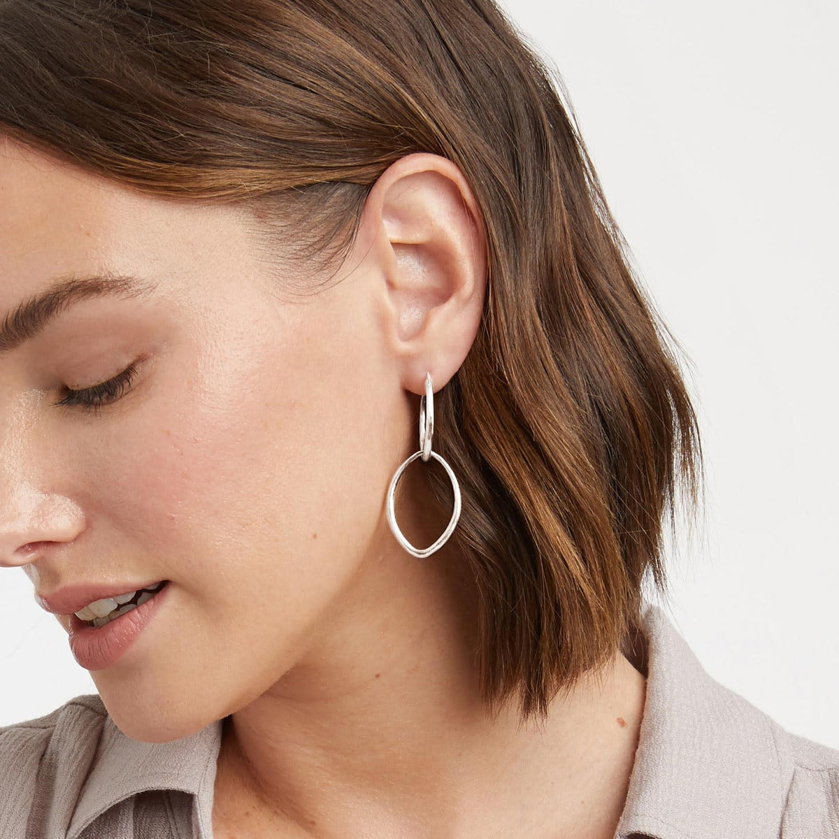 Silver fleur-de-lis hoop earring with hinge closure