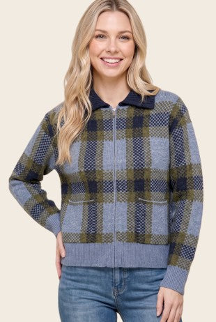 Woman wearing a Patrice Check Jacquarded Collared Cardigan in blue and olive plaid with a zip front.