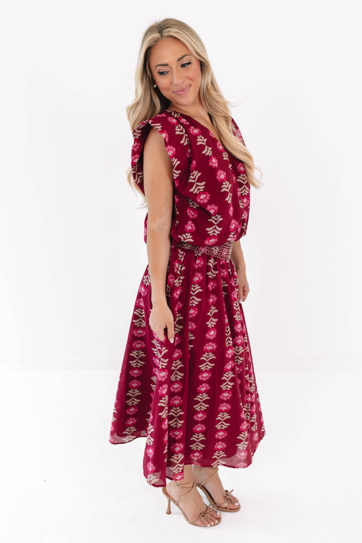 Woman wearing the wine-colored Jane The Bubble Top with a matching printed midi skirt and heels.