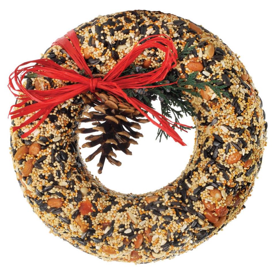 Wildfeast Wreath: a round dried floral arrangement with natural tones, finished with a rustic raffia bow.