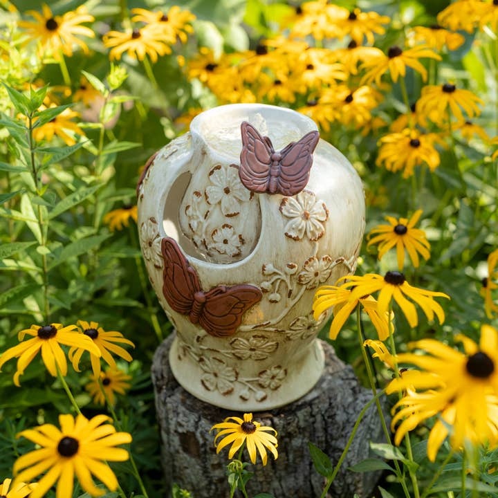 Ceramic water fountain with vintage rustic finish featuring butterfly floral relief pattern.