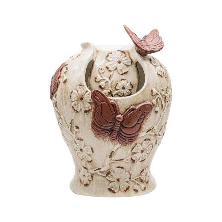 Ceramic water fountain with vintage rustic finish featuring butterfly floral relief pattern.