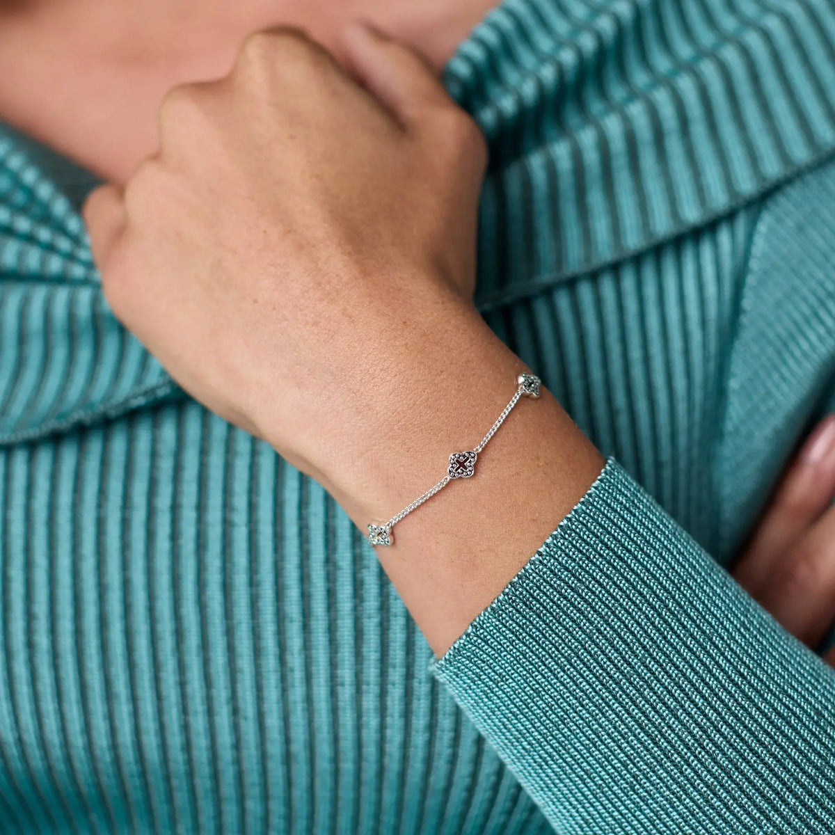 Silver Florentine delicate bracelet with petite quatrefoil stations on a slender adjustable chain.