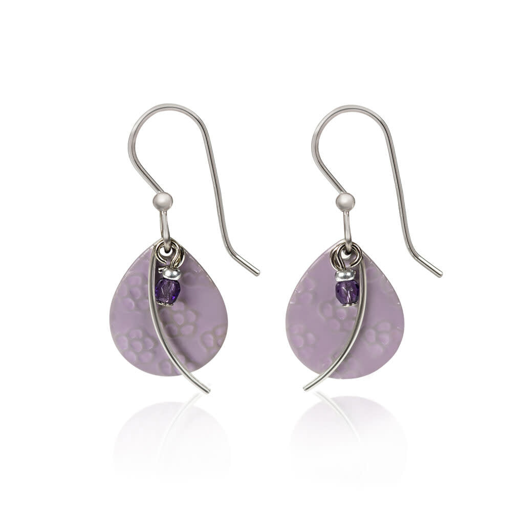 Drop earrings with a flower-textured silver tear shape, metal wisp arc accent, and dangling amethyst bead.