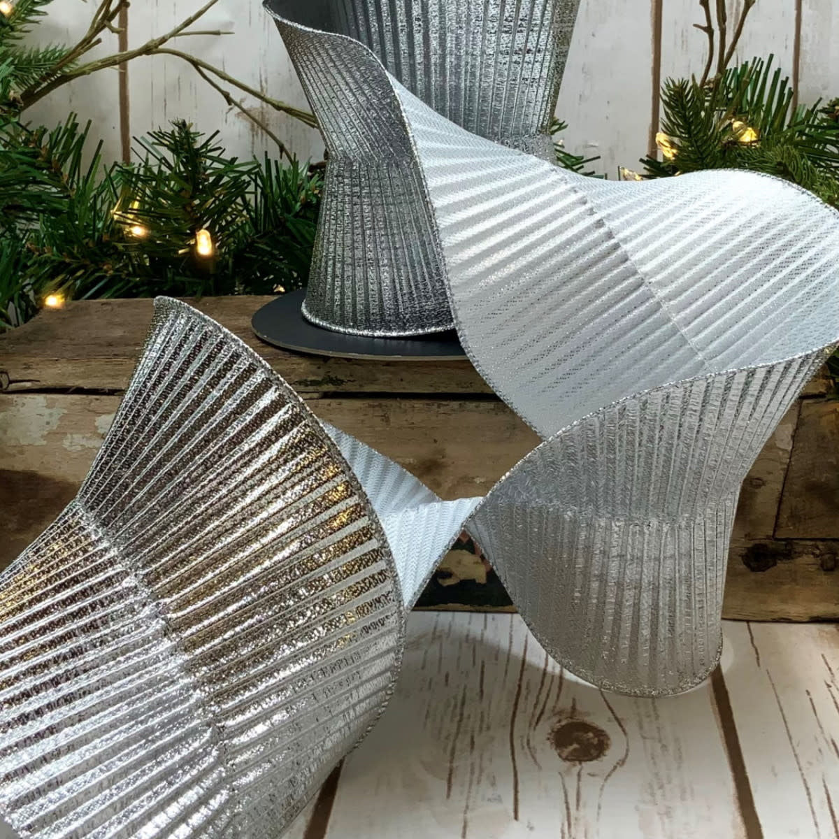 Silver fluted lame ribbon with a shiny metallic finish.