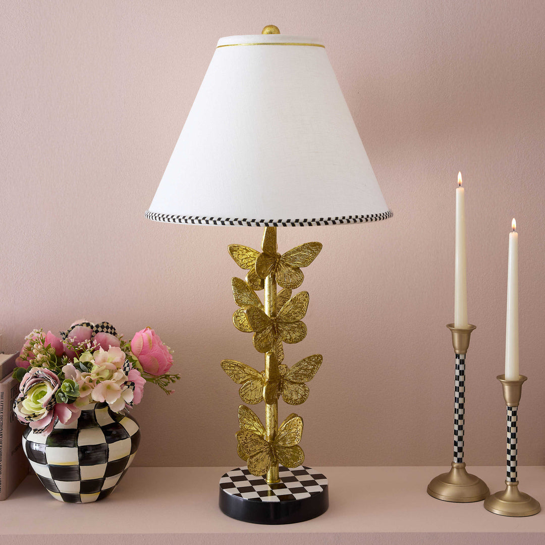 Flutter table lamp with brass leaf butterfly stack on check-patterned hardback shade