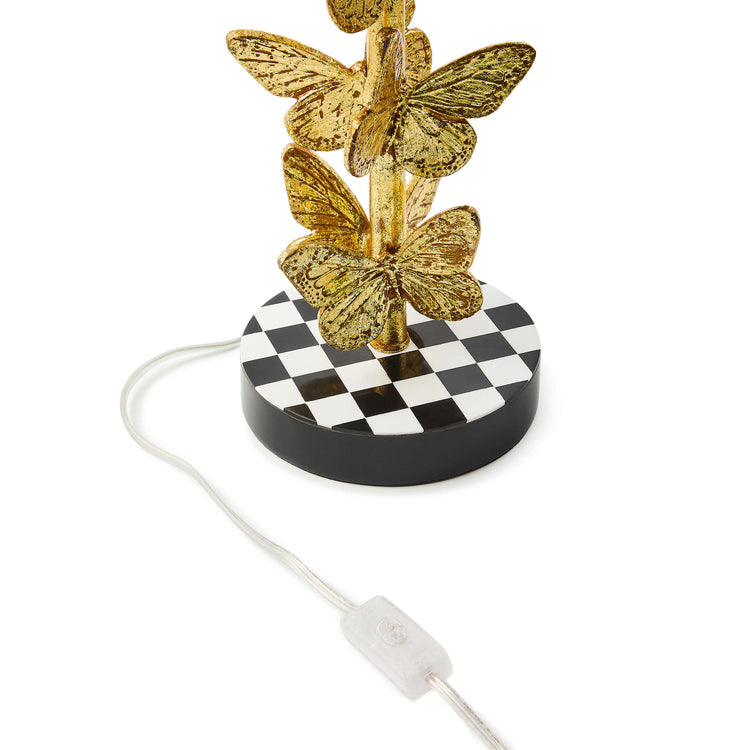 Flutter table lamp with brass leaf butterfly stack on checkered hardback shade