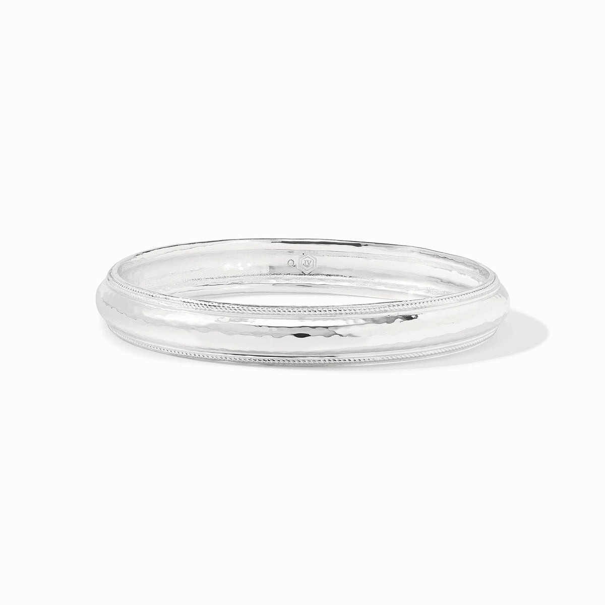 Gold-tone Cannes bangle bracelet with a smooth cylindrical shape.