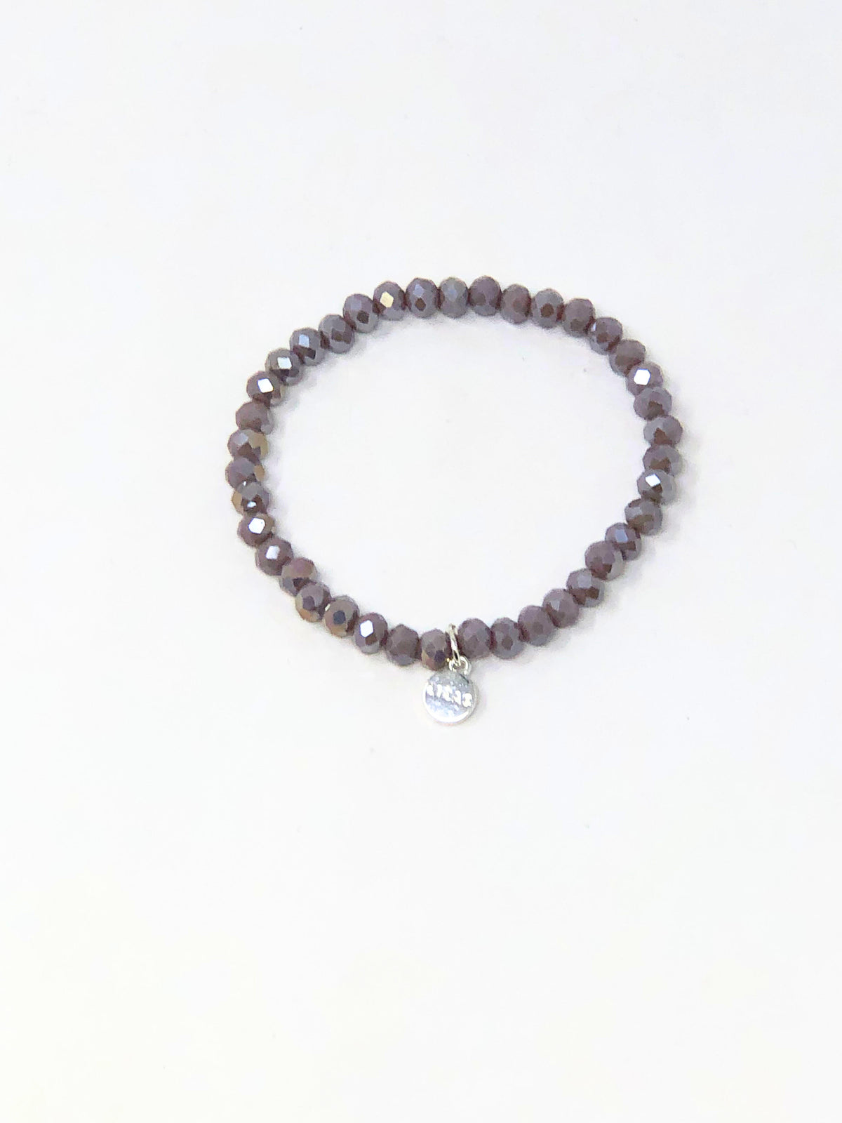 Stretchy bracelet with faceted glass beads in a colorful beaded pattern.