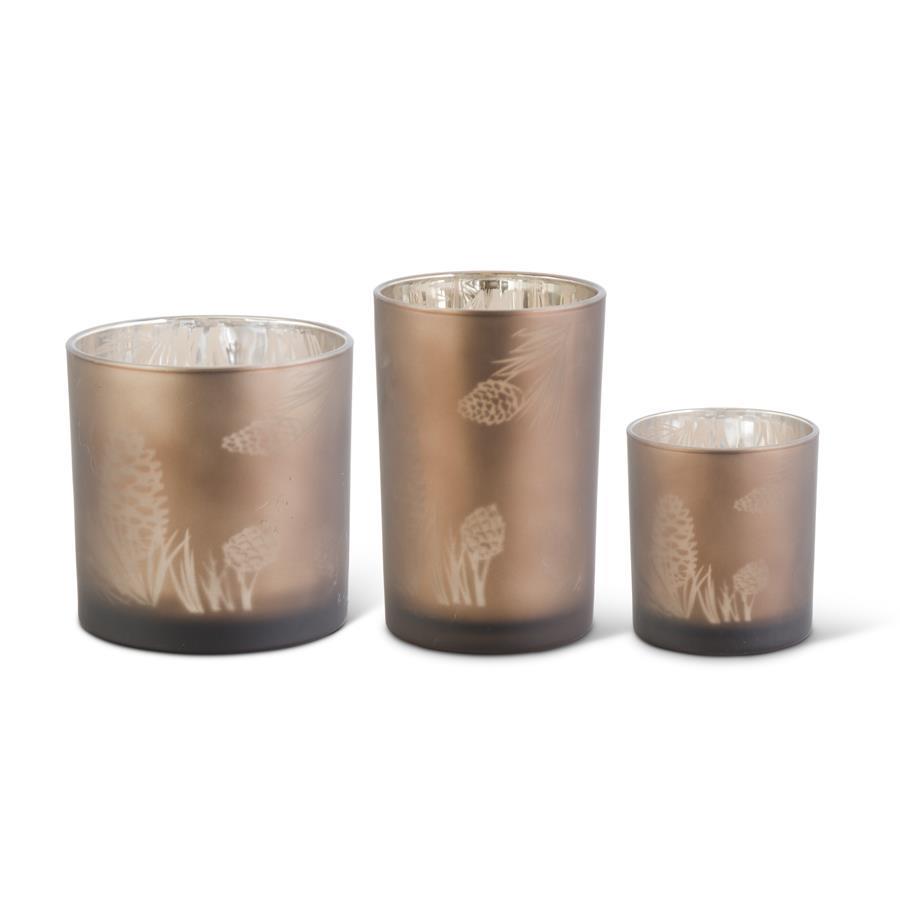 Set of three frosted brown glass containers in varying sizes with etched pinecone patterns.