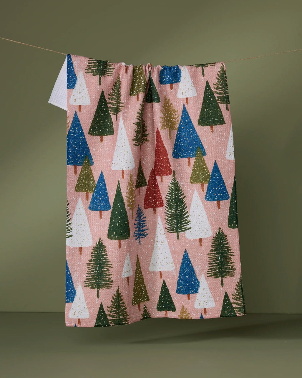 Holiday tea towel with waffle weave construction in red featuring a festive snowflake pattern.