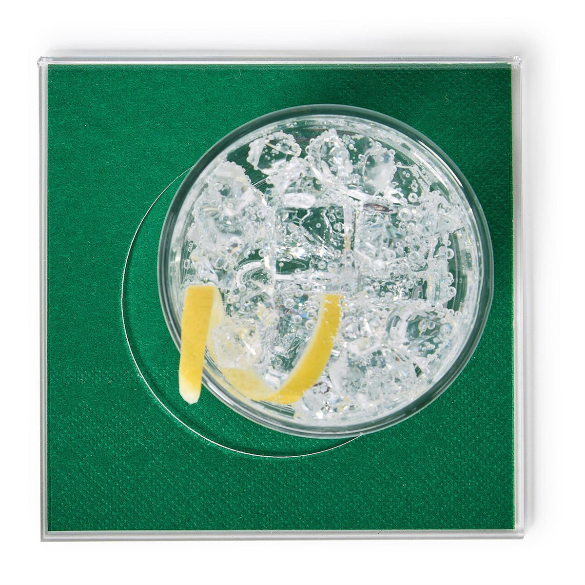 Top view of a clear acrylic square coaster with a green insert holding a glass of sparkling water.