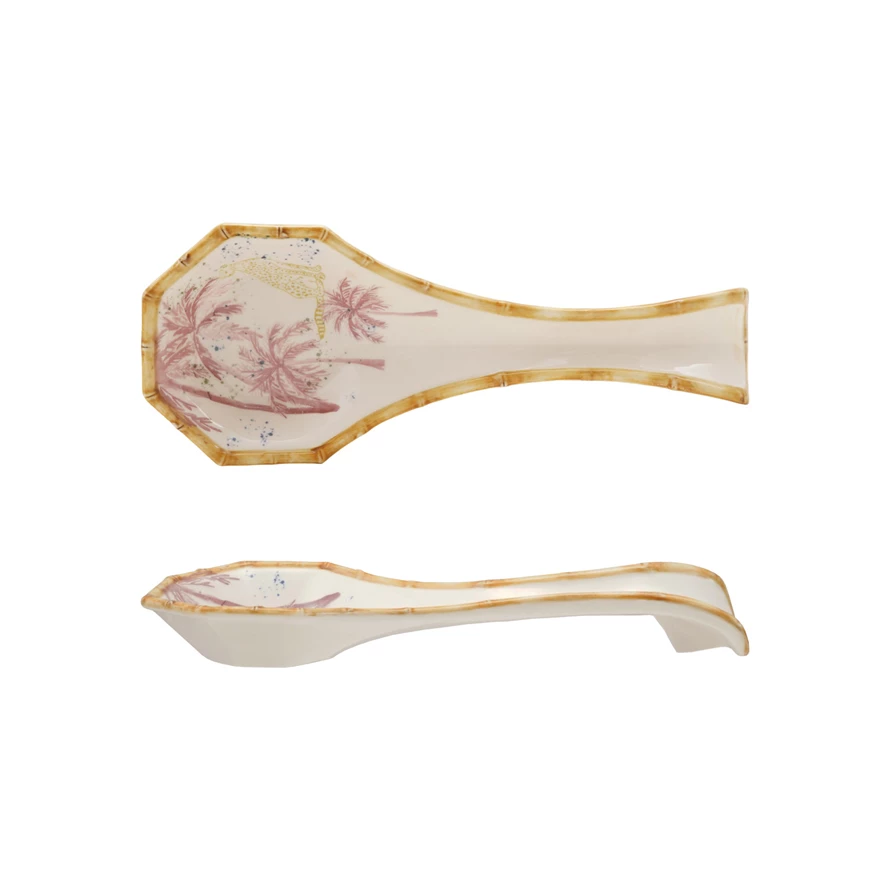 Spoon rest with palm tree motif on white ceramic featuring cheetah print edge and bamboo-style rim.