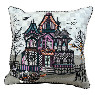 Haunted house throw pillow with black fabric featuring a white spooky mansion pattern.