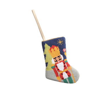 Mini needlepoint stocking with canvas backing in red featuring a classic Santa pattern silhouette.