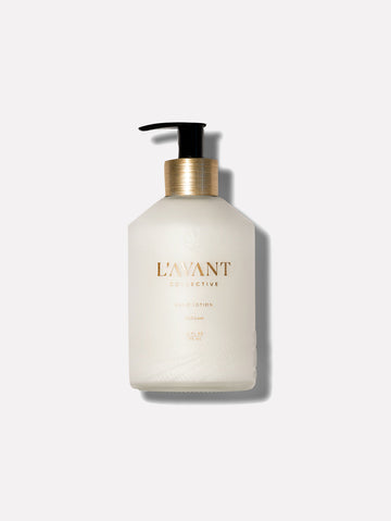 Hand Lotion in Fresh Linen scent inside a durable glass bottle with a recyclable brushed gold pump neck.