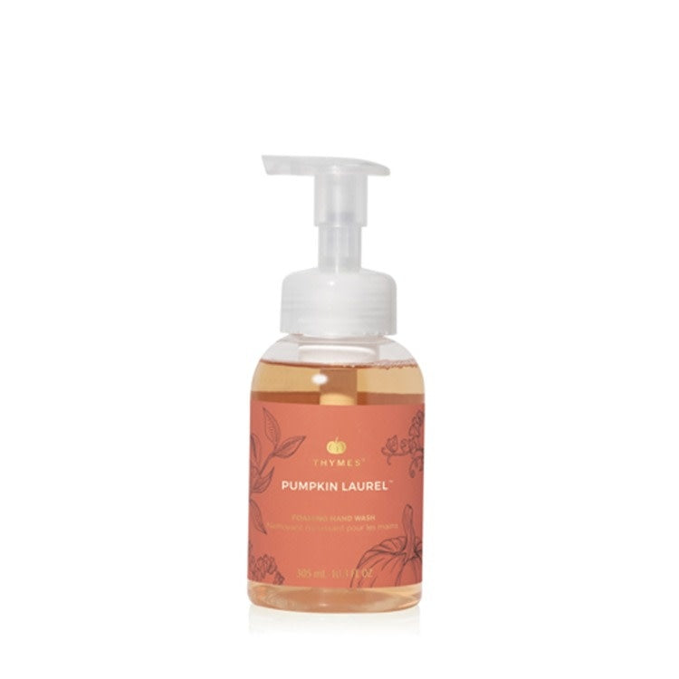Foaming hand wash bottle with a warm pumpkin-colored label featuring laurel leaf accents.